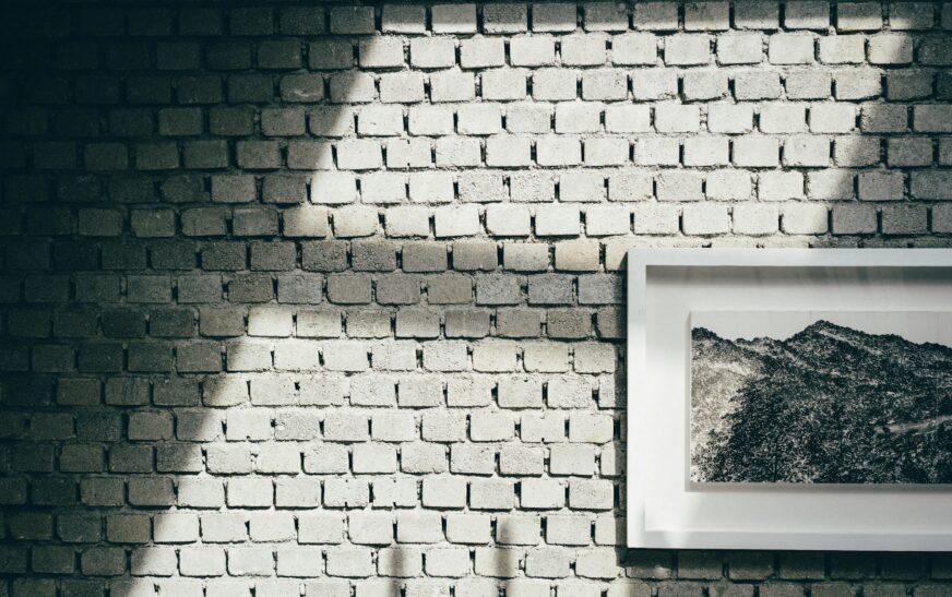How to Hang Pictures on Brick Walls Without Turning Your Wall Into Swiss Cheese